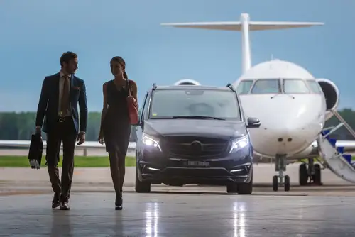 Mercedes benz Airport black car service Infront of a private aircraft in an airport